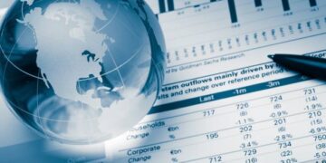 A globe on top of a business report.