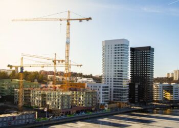 Construction site with cranes and new high-rise buildings. Sustainable development in emerging economies. - Supply Chain News