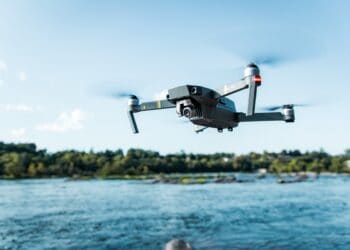 Drone flying over a river. - Supply Chain News