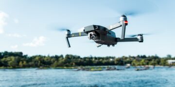 Drone flying over a river. - Supply Chain News