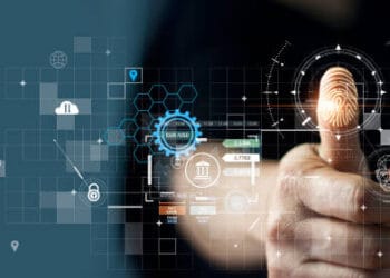 A person is pointing at a finger on a computer screen while using the GXBank Beta App for digital banking.