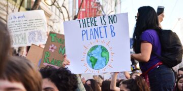 Climate change protestors holding signs reading "There is no Planet B" and "Green New Deal". - Supply Chain News