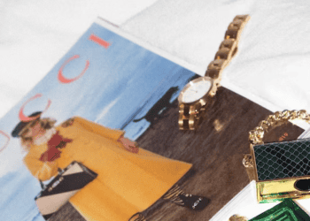 An E-Commerce magazine featuring a luxury brands purse and watch showcased on a bed, just in time for Singles' Day.