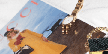 An E-Commerce magazine featuring a luxury brands purse and watch showcased on a bed, just in time for Singles' Day.