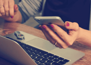 Woman using smartphone and laptop, shopping for luxury goods online. - Supply Chain News