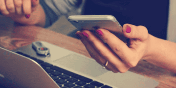 Woman using smartphone and laptop, shopping for luxury goods online. - Supply Chain News