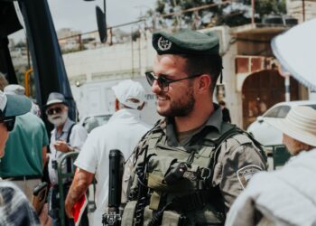 Israeli Border Police officer in uniform, sunglasses, and beret. - Supply Chain News