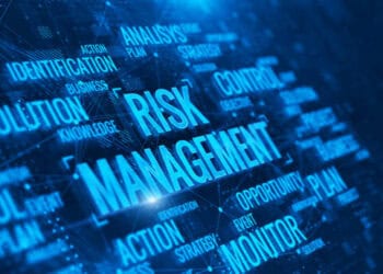 The word risk management on a blue background with implications on AI.