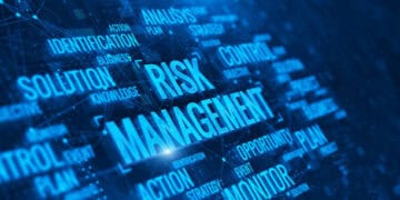The word risk management on a blue background with implications on AI.