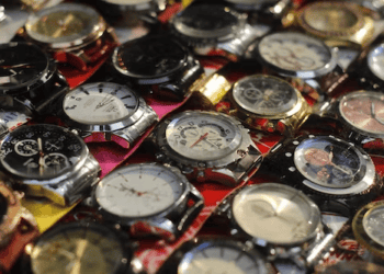 Close-up of numerous counterfeit luxury watches, highlighting the prevalence of fake timepieces. - Supply Chain News