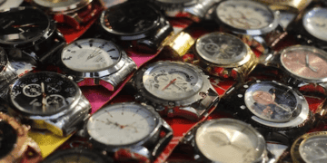 Close-up of numerous counterfeit luxury watches, highlighting the prevalence of fake timepieces. - Supply Chain News