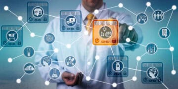 A man in a white coat is pointing at a network of technology icons.