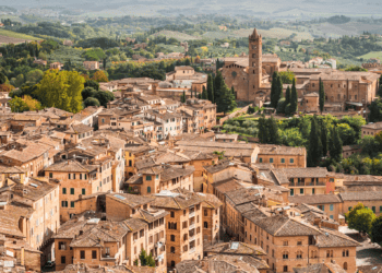 Aerial view of terracotta rooftops in Tuscany, Italy. Luxury villas and historic architecture. - Supply Chain News