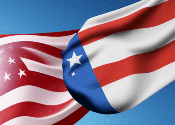 Two American flags waving in the wind symbolize the trade dynamics and U.S.-China relationship.