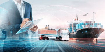 Businessperson using tablet, overseeing global logistics network with cargo ships, trucks, and forklift. IoT in modern supply chain. - Supply Chain News