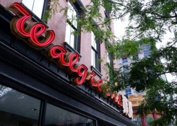 Walgreens store front with illuminated red Walgreens sign. - Supply Chain News