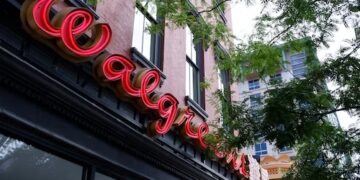 Walgreens store front with illuminated red Walgreens sign. - Supply Chain News