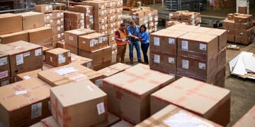 Workers examine inventory in a Kentucky warehouse. Federal investigation into child labor. - Supply Chain News