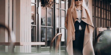 Stylish millennial woman in a beige coat, redefining luxury. - Supply Chain News