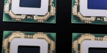 Four Samsung cpu chips on a black surface.