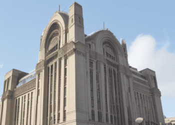 A grand building with a clock tower standing tall in the background.