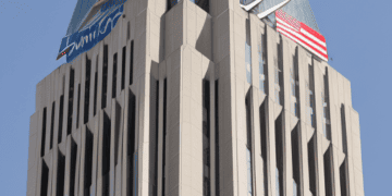 A tall building with an American flag on top, settles with Bank of America for $250 million.