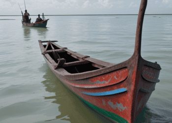 Sri Lankan fishermen face challenges amid economic crises, with two boats in the water.