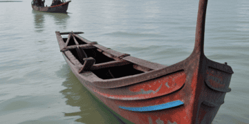 Sri Lankan fishermen face challenges amid economic crises, with two boats in the water.