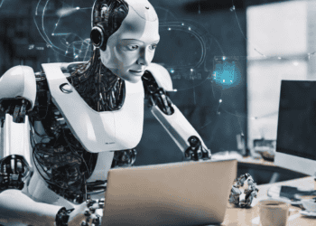 AI robot using laptop, showcasing advancements in AI technology for business operations. - Supply Chain News