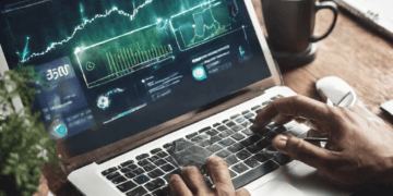 Person using laptop showing fintech data graphs, advancing sustainable economy. - Supply Chain News