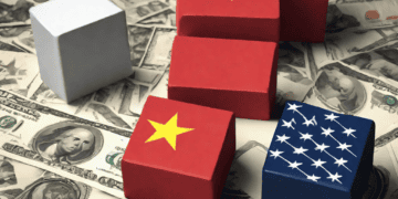 Stacked blocks representing China, Vietnam, and the US, amidst US dollar bills. Illustrates escalating trade tensions. - Supply Chain News