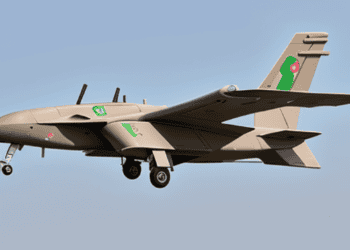 A tan and green plane, part of Erdogan's diplomatic visit, flies in the sky.