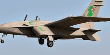A tan and green plane, part of Erdogan's diplomatic visit, flies in the sky.