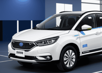 A white SUV, potentially utilized for electric vehicle marketing, is parked in a room.