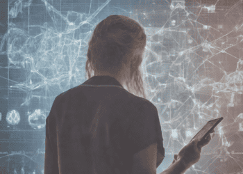 Woman reviewing data on a large screen, possibly related to machine learning in health interventions. - Supply Chain News