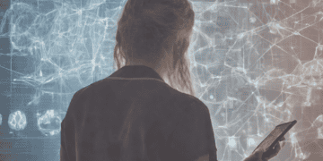 Woman reviewing data on a large screen, possibly related to machine learning in health interventions. - Supply Chain News