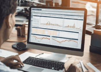 Person analyzing global trade data on computer, enhancing efficiency with GTM systems. - Supply Chain News