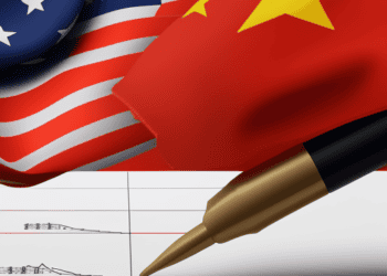 US and China flags with pen signing trade agreement. Global economic impact. - Supply Chain News