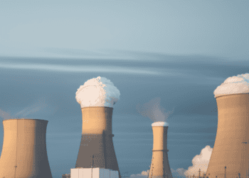 A group of cooling towers used in nuclear energy production, facing challenges in adopting new technologies.