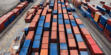 Aerial view of numerous shipping containers at a port, illustrating potential post-Brexit freight flow challenges. - Supply Chain News