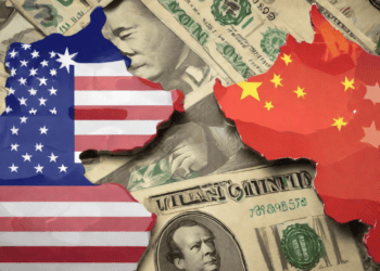 US and China flags shaped as maps overlaid on US dollar bills. Economic tensions. - Supply Chain News