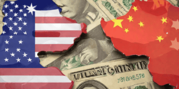 US and China flags shaped as maps overlaid on US dollar bills. Economic tensions. - Supply Chain News