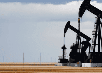 Oil pumps in a field with a cloudy sky, featuring the latest updates on OPEC Report and the impact on Prices.