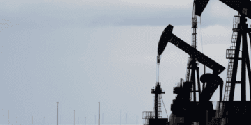 Oil pumps in a field with a cloudy sky, featuring the latest updates on OPEC Report and the impact on Prices.