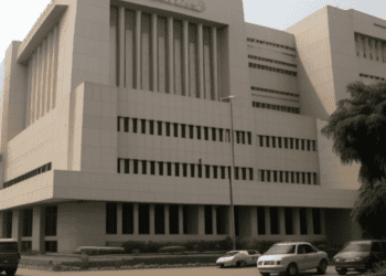 Interim Central Bank of Nigeria Building with cars parked in front of it, led by Folashodun Shonubi.