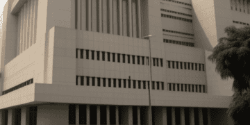 Interim Central Bank of Nigeria Building with cars parked in front of it, led by Folashodun Shonubi.