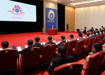 A group of people in a room with a projector, discussing crisis response.