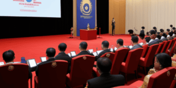 A group of people in a room with a projector, discussing crisis response.