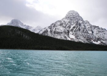 Snow-capped Canadian Rockies reflected in a pristine lake. - Supply Chain News