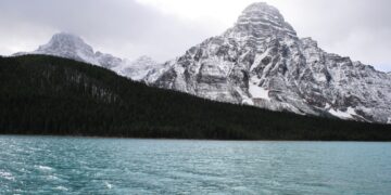 Snow-capped Canadian Rockies reflected in a pristine lake. - Supply Chain News
